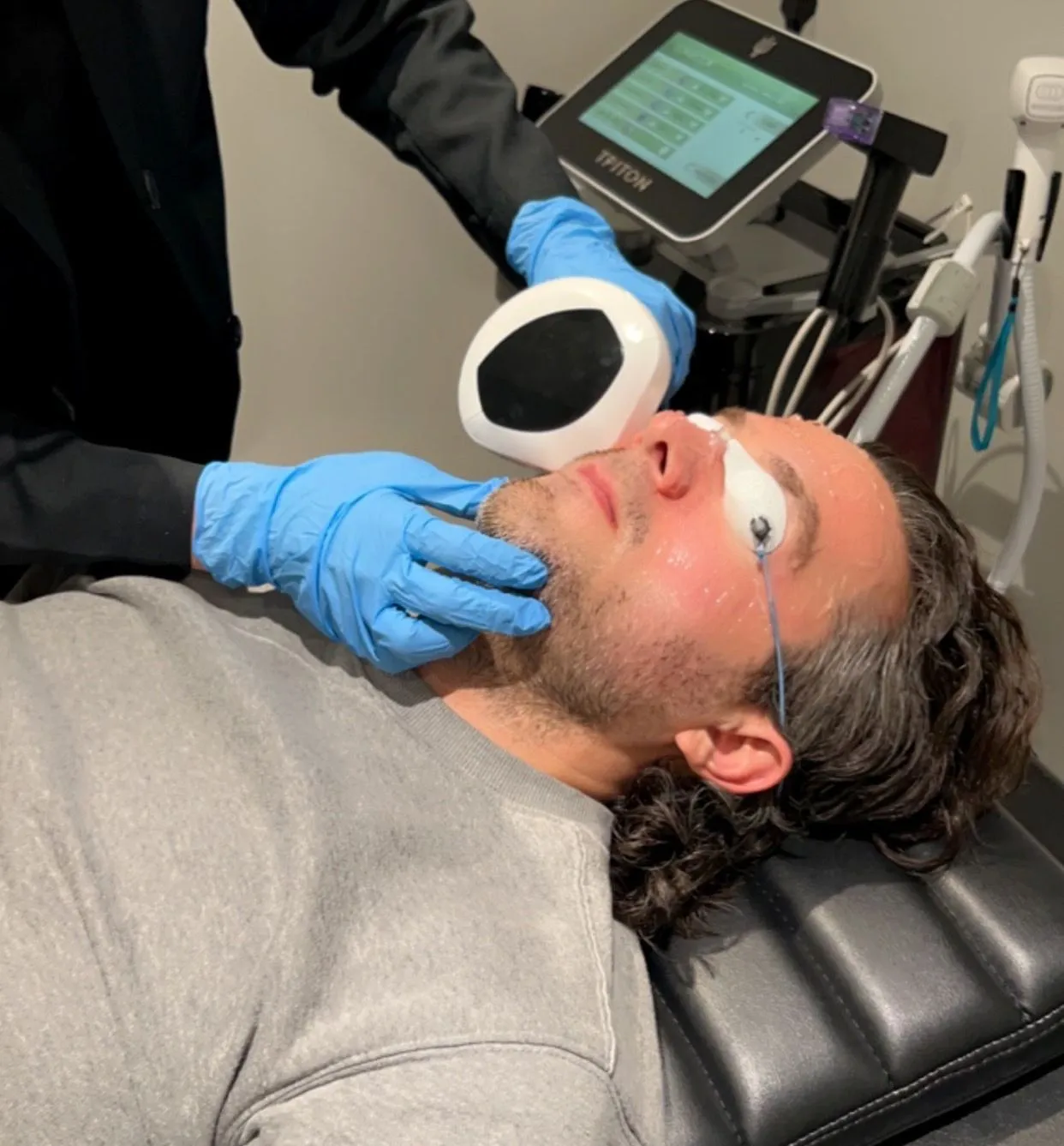 Middle-aged man receiving skin treatment